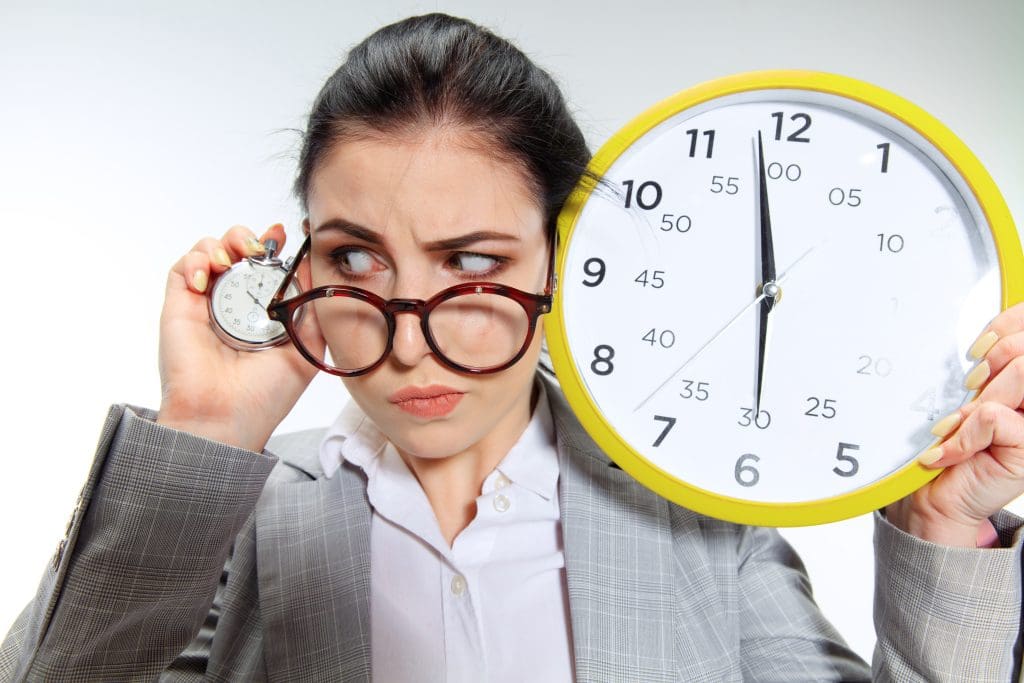 young woman can t wait go home from nasty office holding clock waiting five minutes before end scaled